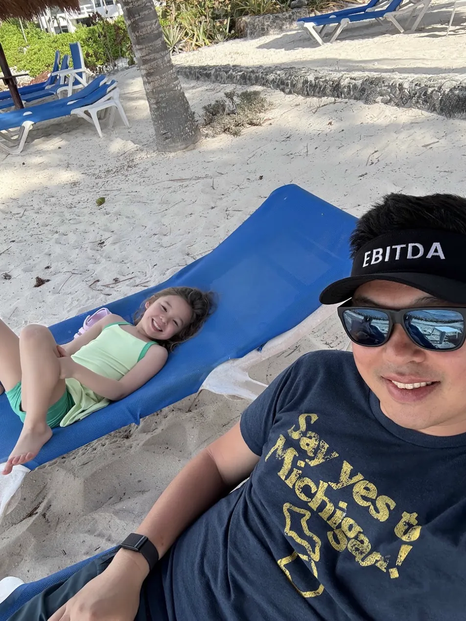 Founder wearing the original EBITDA visor on a beach in Mexico
